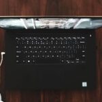 second hand laptop - black and gray laptop computer turned on on wooden surface