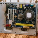 how to check refurbished laptop is genuine - a computer motherboard sitting on top of a wooden floor