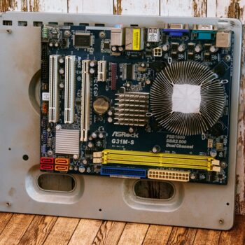 how to check refurbished laptop is genuine - a computer motherboard sitting on top of a wooden floor