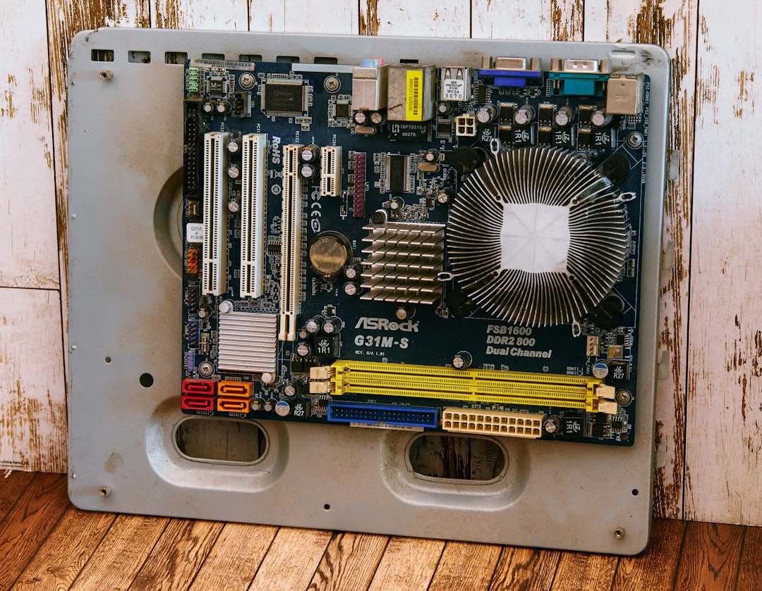 how to check refurbished laptop is genuine - a computer motherboard sitting on top of a wooden floor