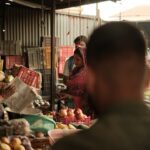 refurbished HP laptop India - a group of people standing around a fruit stand