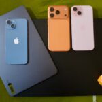 laptop for work from home india - Three iphones and a tablet on a green surface.