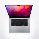 laptop under 25000 - a laptop computer with a colorful design on the screen