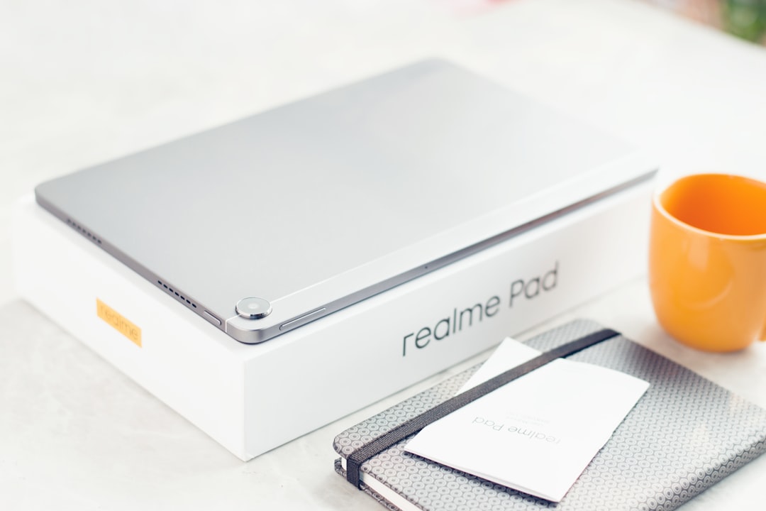 refurbished gaming laptop India under 50000 - a laptop computer sitting on top of a table next to a cup