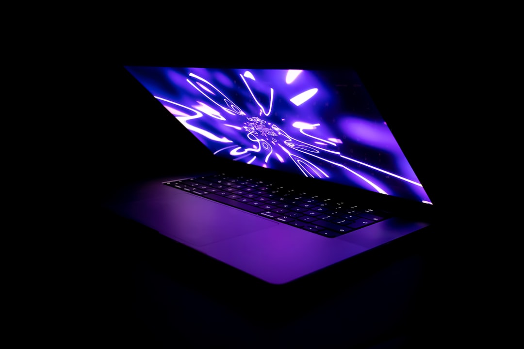 refurbished gaming laptops - a laptop computer with a glowing screen in the dark