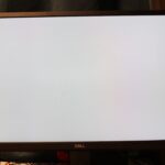 dell latitude 5420 - A big screen TV sitting on top of a wooden stand