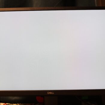 dell latitude 5420 - A big screen TV sitting on top of a wooden stand