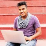 refurbished laptop workspace India - Edify | Blogs woman in purple shirt and blue denim jeans sitting on concrete bench