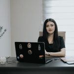 business laptop office desk - Edify | Blogs Woman sitting at desk with laptop and plant.