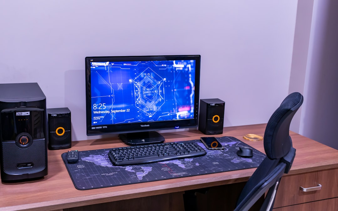 a desk with a computer and speakers on it