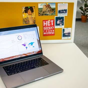 a laptop computer sitting on top of a white desk