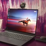 Laptop displaying a horse racing on its screen.