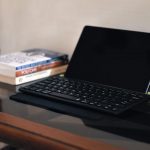 a laptop computer sitting on top of a wooden table