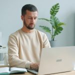 Man working on a laptop at a desk.