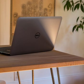 gray Dell laptop on table