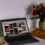 A laptop computer sitting on top of a white desk