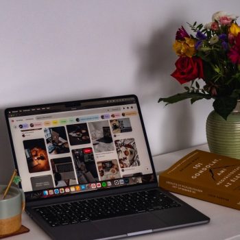 A laptop computer sitting on top of a white desk
